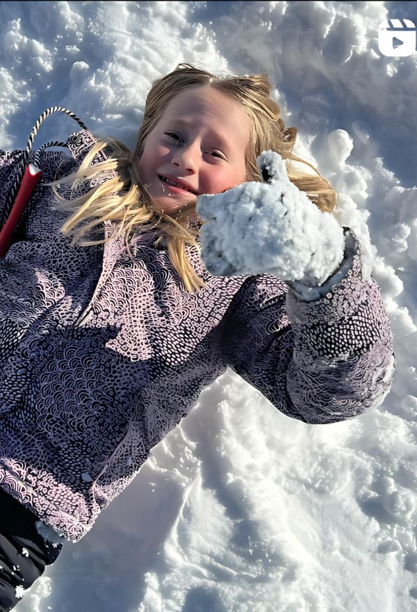 Macaroni KID Overland Park - Olathe - Shawnee KS publisher's daughter laying in the snow