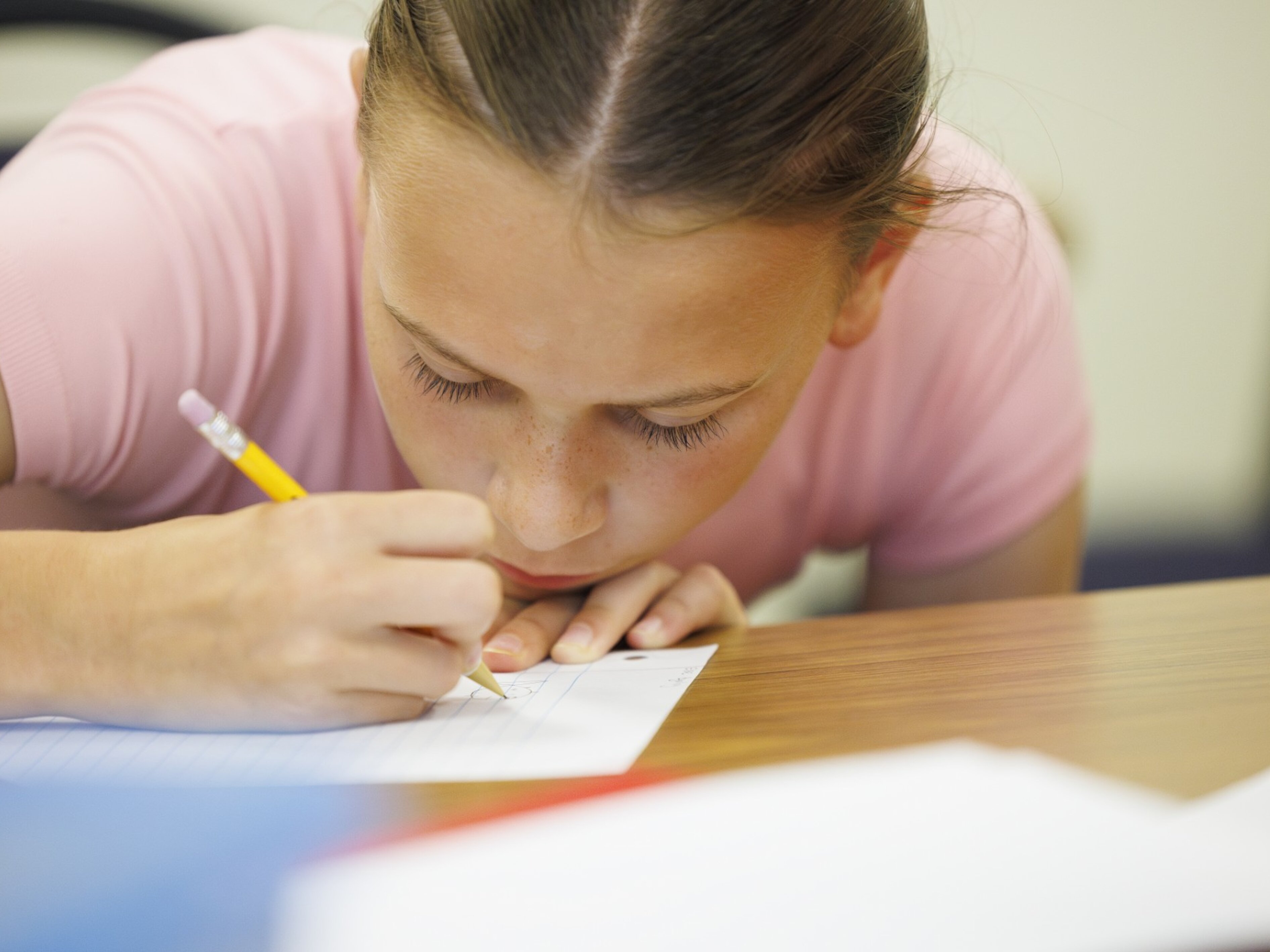 Child writing with a pencil