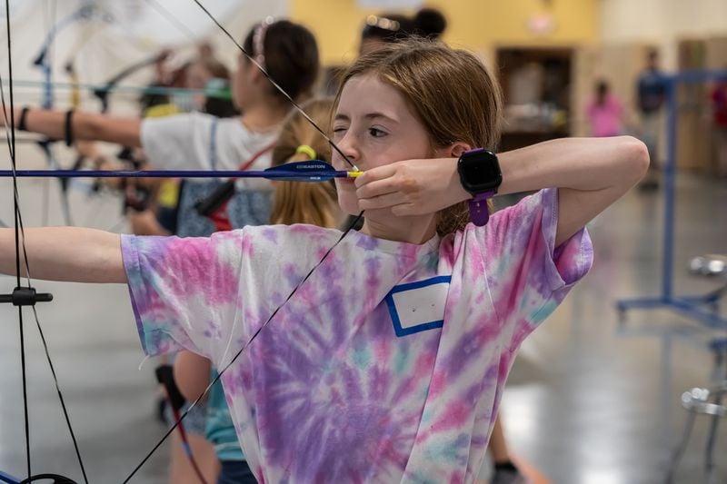 Child shooting a bow and arrow