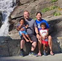 family in front of waterfall