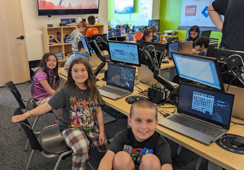 smiling boys and girls in a Code Ninjas coding class