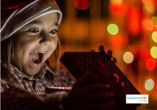 little girl excitedly opening gift