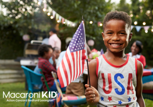young boy holding american flag