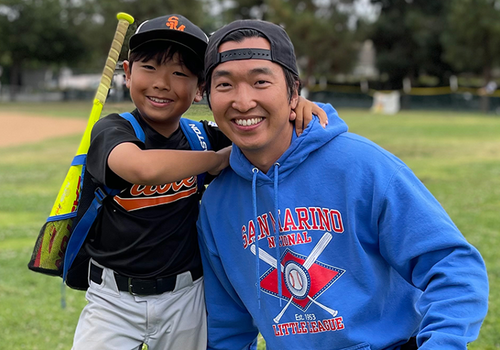 Little League, Coach and player smiling