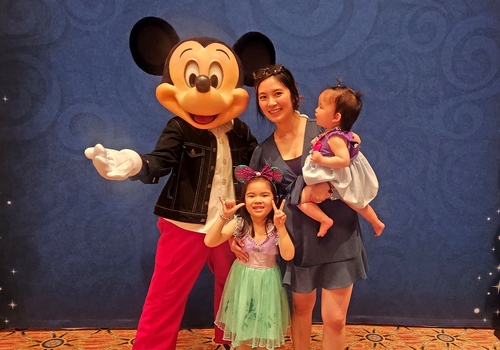 Essy and family with Mickey Mouse at Walt Disney World