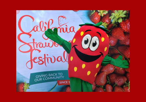 California Strawberry Festival, Strawberry mascot with a background of strawberries