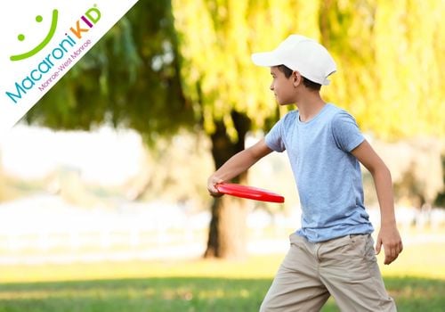 Young Boy Playing Disc Golf at a Local Park