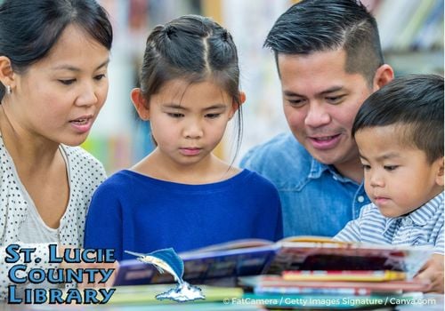 Family reading together at the library