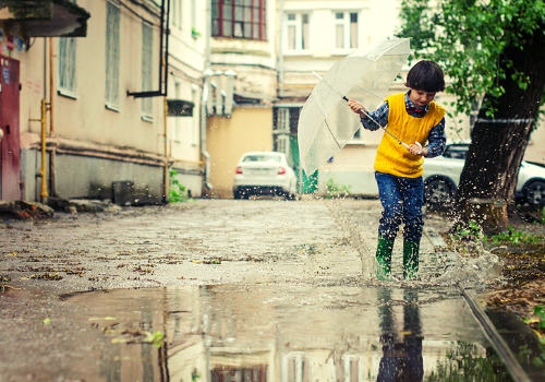 kid playing in the rain