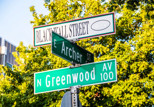 corner of Greenwood and Archer.Black Wall Street and N Greenwood Avenue and Archer street signs - closeup - in Tulsa Oklahoma with bokeh background