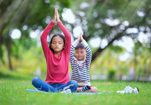 Children doing yoga in the park