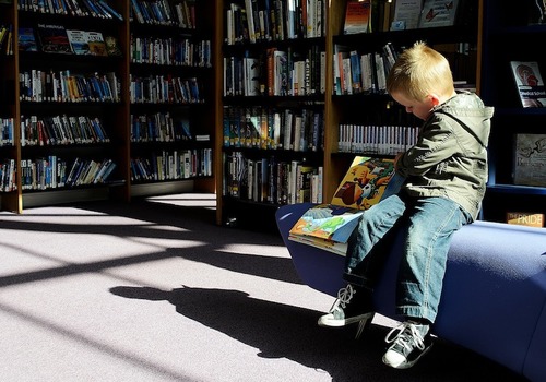 child reading in library