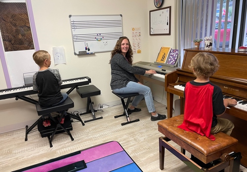 Grace Piano Studio: Piano lessons with Alyssa and two children