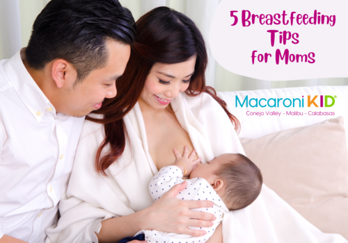 Mom breastfeeding newborn with dad looking - 5 breastfeeding Tips for Moms