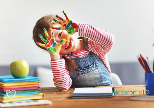 Happy child with paint on her hands