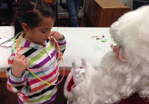 santa talks to little girl light up the holidays