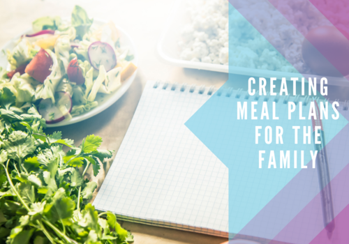 Meal Planning notebook next to salad and fresh ingredients