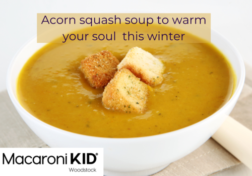 A hearty bowl of squash soup with three croutons.