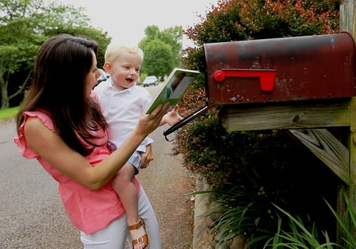 parent and child finding a free book in their mailbox