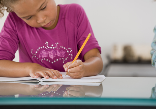 young black girl writing a story