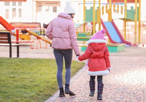 woman walking with little girl