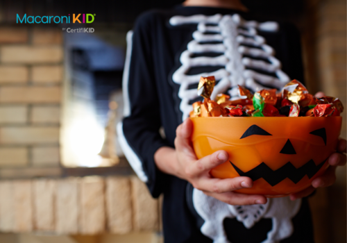 Kid with halloween candy bucket