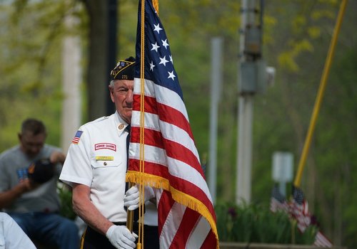 Military veteran holding a US flag