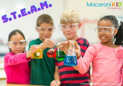 Kids wearing science goggles holding beakers containing fluid