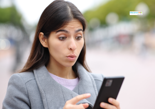 woman looking at phone, upset look on face