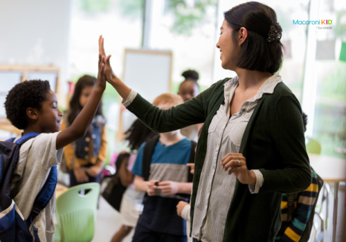 teacher giving students a high five