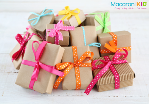 pile of packages wrapped in brown paper and bright colored ribbon