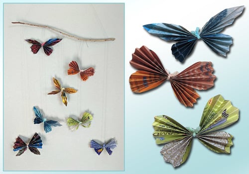 Recycled Magazine Butterflies hanging from a wall