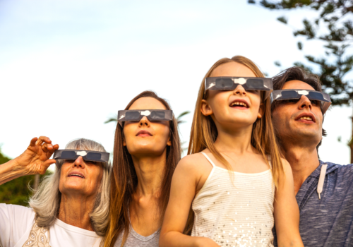 An image of a family with solar eclipse glasses on in New Jersey