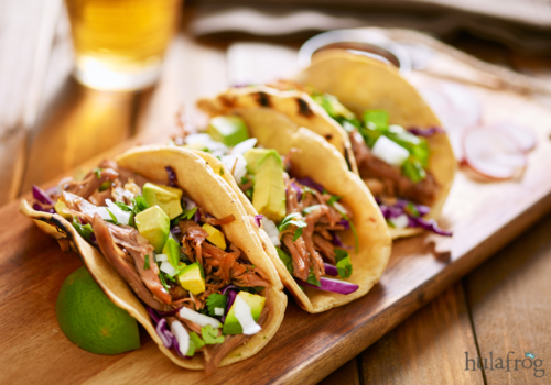 three pork carnitas street tacos