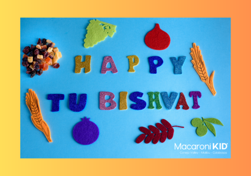 Happy Tu Bishvat in felt letters with seasonal fruits and nuts