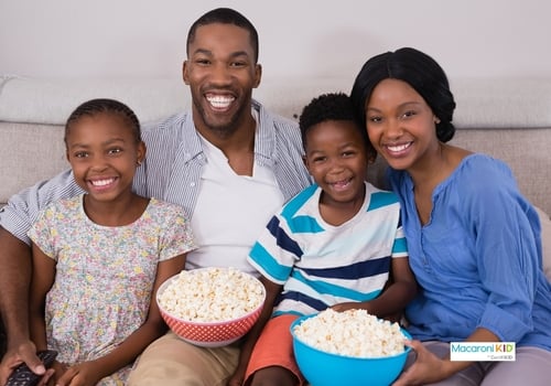 Cheerful family with popcorn bowls