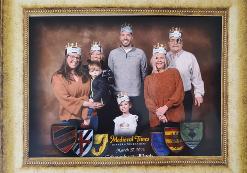 Image of 4 adults and two children with crowns.