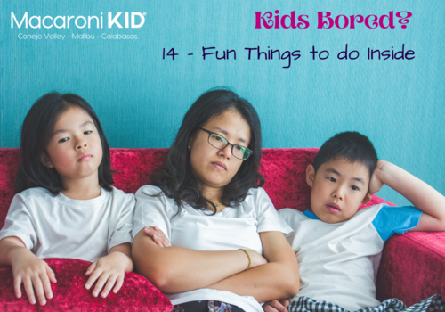 Mom, son and daughter sitting on a red sofa looking Bored
