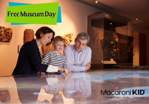 Free Museum Day - parents showing things to a young boy at the Museum