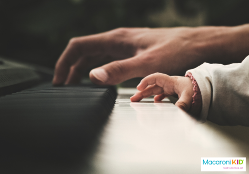 parent and infant playing piano together