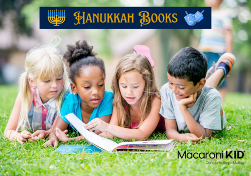 Hanukkah Books, four kids lying on the grass looking at a book together