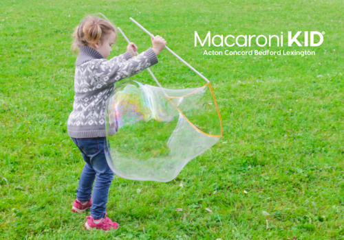 young girl playing with large bubble
