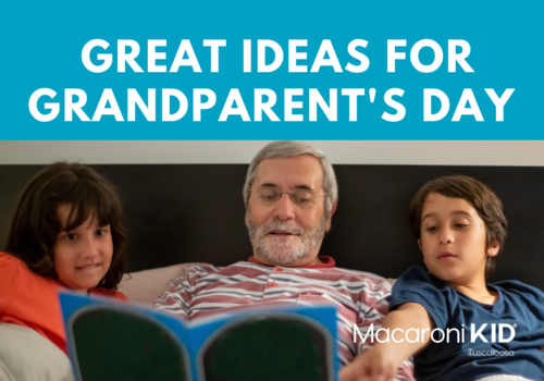 title great ideas for grandparent's day, two children with olive skin tones read a card with grandfather on a bed