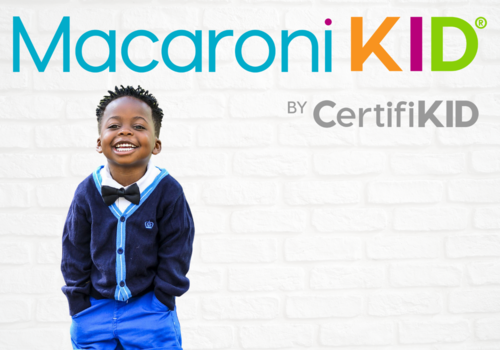 new Macaroni Kid logo with litlle boy smiling against wall