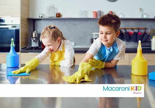 two kids cleaning the kitchen counter
