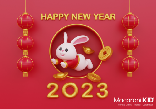 2023 Happy New Year in gold against a red background with a Rabbit and gold coins