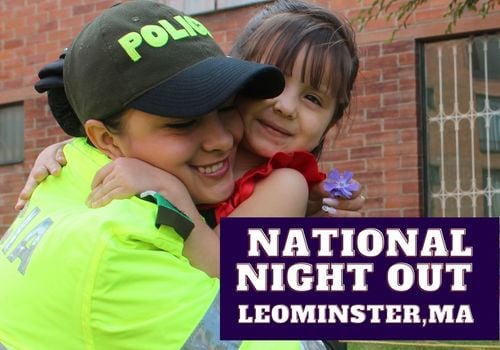Female police office hugging young child, smiling. Text reads NATIONAL NIGHT OUT - LEOMINSTER
