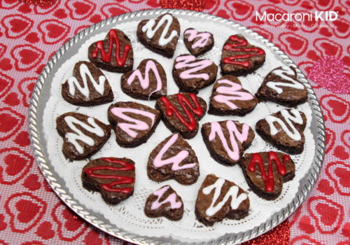 Heart shaped brownies on a plate on a table with red heart tablecloth