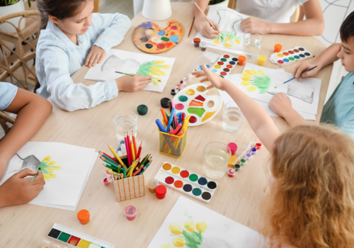 Cute child painting during master-class in art