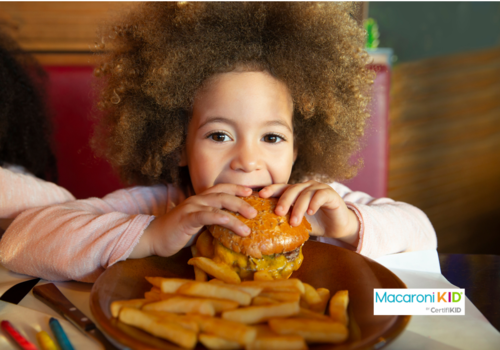 kid  eating burger and chips